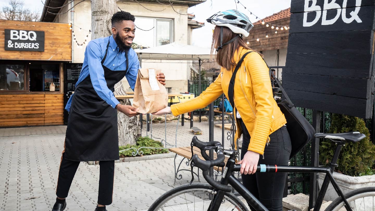 Man giving woman her order