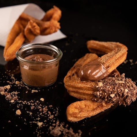 churros dipped in chocolate sauce
