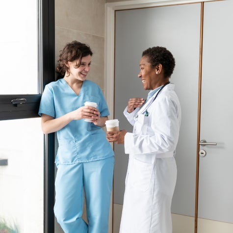 Nurse and doctor chatting over coffee