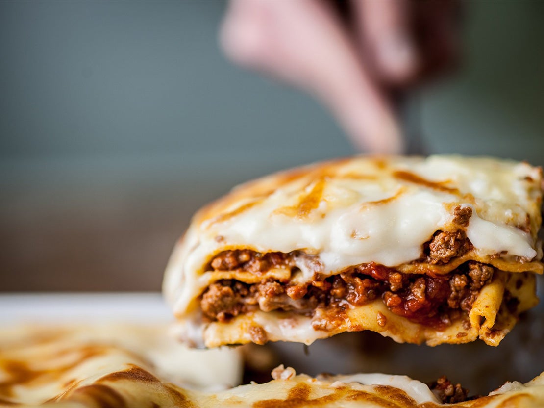 serving a portion of lasagne