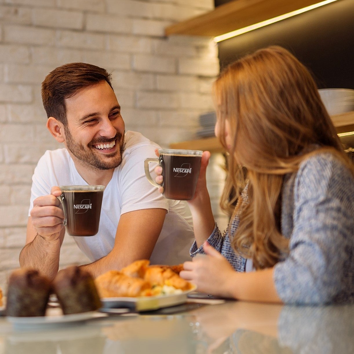 two people drinking nescafe coffee in an office
