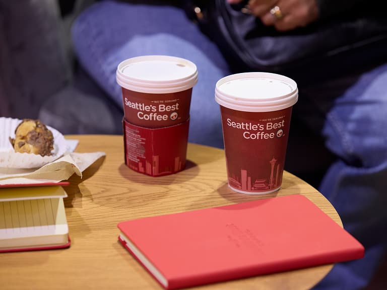 2 Seattle's Best Coffee cups on table